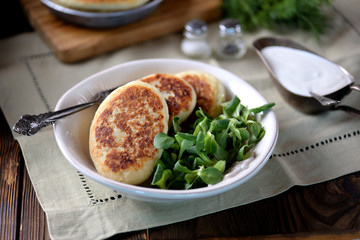 Potato cakes with cheese, yogurt sauce and lettuce leaf. 
