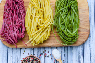Still life with pasta ingredients on the wooden background