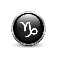 Capricorn zodiac symbol, black button with metal frame and shadow