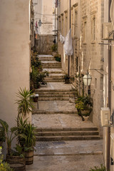 Narrow street with stairs in Old Town Dubrovnik  - obrazy, fototapety, plakaty