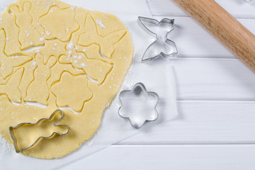 Making homemade sugar cookies in a variety of forms. Roll out the dough.  Cut Easter figures