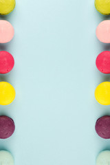 Colourful french macaroons on the blue background, Top view