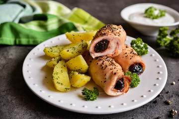 Roasted chicken chops stuffed with bacon and dried plum garnished with potato
