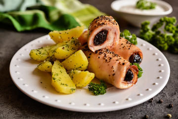Roasted chicken chops stuffed with bacon and dried plum garnished with potato