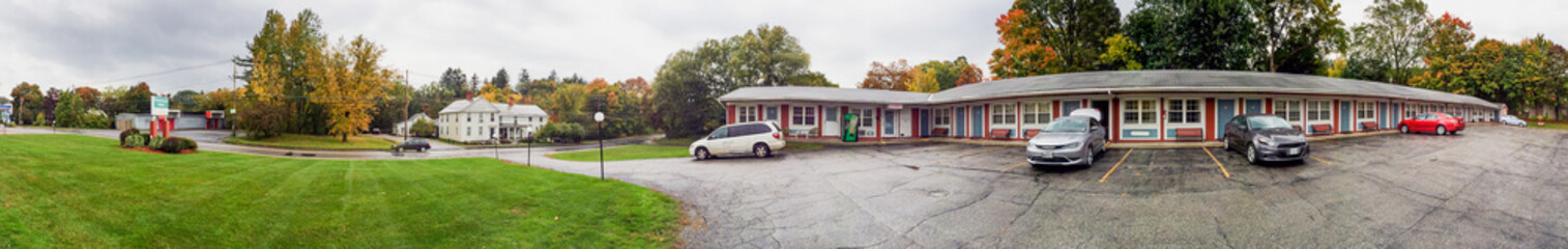 Fototapeta na wymiar Motel parking and meadows in foliage season, New England, USA