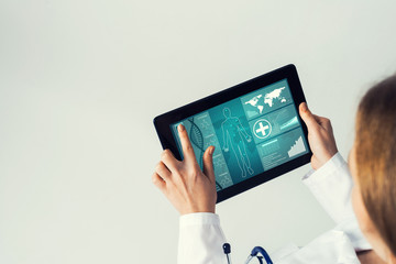 Close of female doctor hands working with tablet pc computer