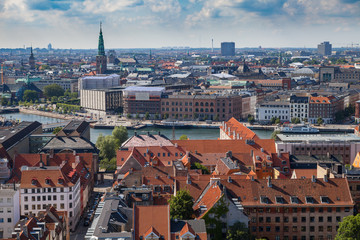 Fototapeta na wymiar Aerial view of Copenhagen red roofs and canal. Churches and palaces of Danish capital.
