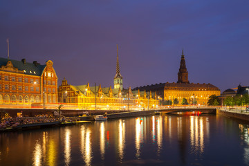 Night view on Christiansborg Palace and Stock Exchange building over the channel in Copenhagen.