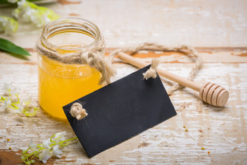 Honey in jar on wooden table