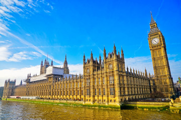 View of the Houses of Parliament with sunny sky in the background.
