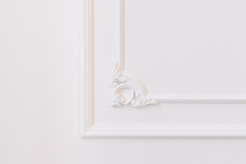 White wall decorated with stucco and molding in the style of Renaissance, Baroque.