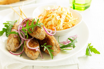 Kyufta kebab with salad close-up.