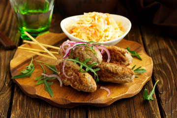 Kyufta kebab with salad close-up.