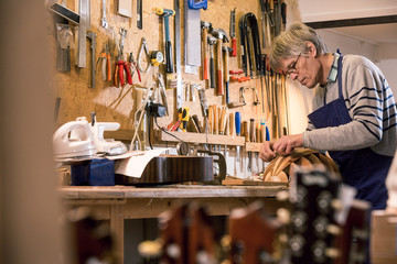 Luthier carving the body of a lute