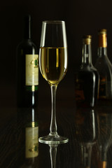 Wine glass and Bottle on a black mirror background