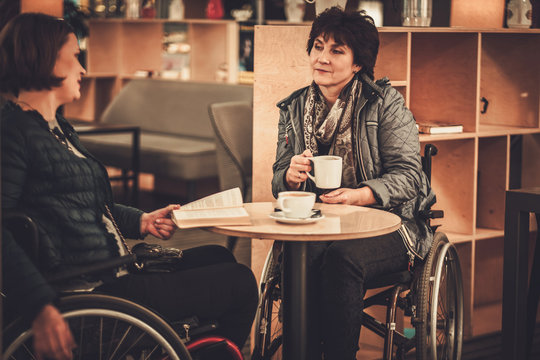 Two Physically Challenged Women In A Cafe