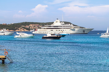 Fototapeta na wymiar Luxury yachts at Porto Massimo bay at Sardinia Island, Italy