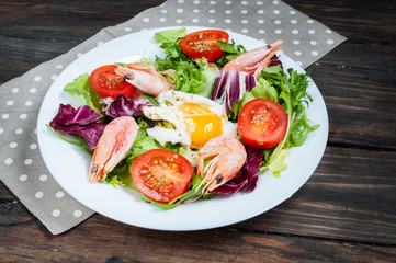 Healthy Shrimp and Arugula Salad with Tomatoes on a wooden table