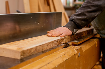 Young carpenter working with a wood