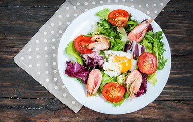 Healthy Shrimp and Arugula Salad with Tomatoes on a wooden table
