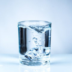ice cube in glass of water