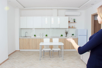 Real estate agent presenting modern house to client, woman Shows the kitchen.