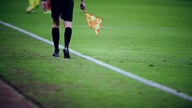Assistant referee moving along the sideline during a soccer match