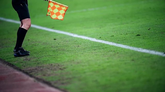 Assistant referee moving along the sideline during a soccer match