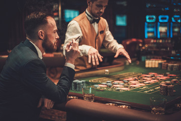 Upper class man gambling in a casino