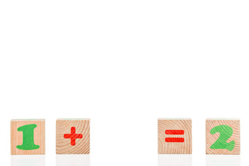 Obraz premium Simple mathematical example of wooden cubes isolated on white background