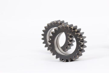 Small group of gears with their teeth engaged on a white background.