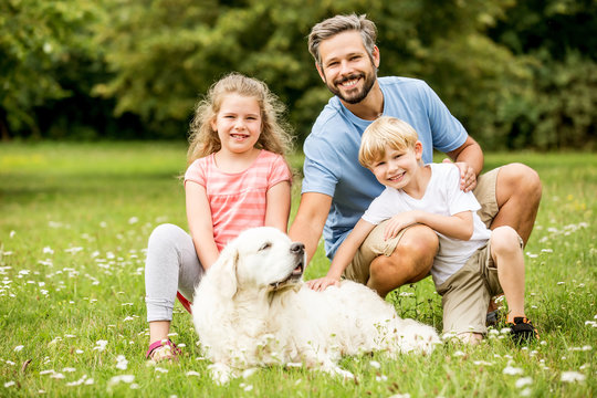 Vater und glückliche Kinder mit Hund