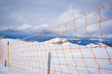 protection net,Ski slope run safety net mesh mountain protection wall fence,wire fence and snow. chain-link fence. wire mesh fence in the snow. texture, background,selective focus,vintage color