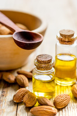 organic cosmetic with almond extract on table background