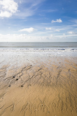 Fototapeta na wymiar sandy beach in Vendee, France with blue sky and white clouds