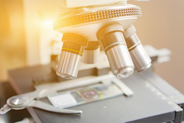 medical laboratory, scientist hands using microscope for chemistry test samples,examining samples and liquid,Medical equipment. microscope,Scientific and healthcare research background.vintage color