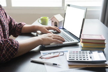 Cropped shot view of young smart business male use on-line via laptop computer for analyzing financial chart,writing business plan,open net-book with copy space screen,morning light,vintage color