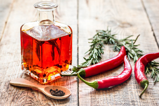 chili oil with ingredients on kitchen table background