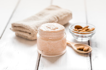 cosmetic for women with almond scrub on desk background