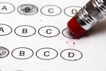Standardized quiz or test score sheet with multiple choice answers pencil, and eraser.