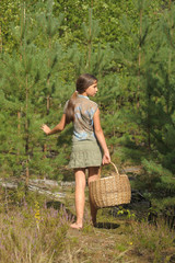Girl with a basket to collect mushrooms IN THE FOREST