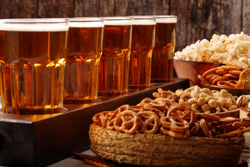 Beer row and snacks on wooden background football fan set