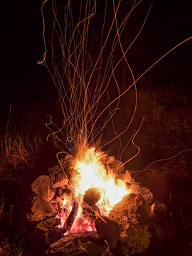 Campfire Fireworks - Light trails from campfire embers on a dark mountain night.