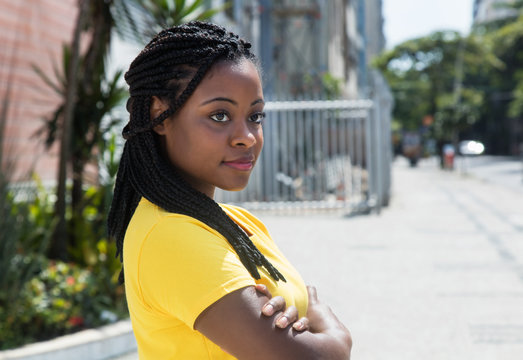 Smiling African American Woman In Yellow Shirt Looking Sideways