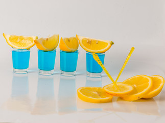 Four glasses of blue kamikaze, glamorous drink, mixed drink poured into shot glasses