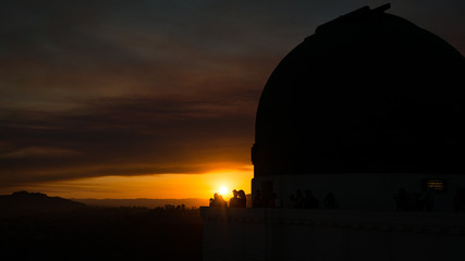 Young people having fun at sunset in Griffith Observatory, Los Angeles, California, USA