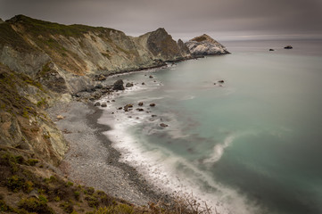 Rocky beach and cliffs close to Pacific Coast Highway at Willow Creek point, California, USA