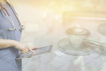 Female doctor,surgeon holding using tablet pc computer at work,Healthcare And Medicine,during the conference on blurred background ambulance speeding through the streets.in vintage color