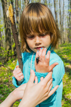 Girl with a bug on a hand
