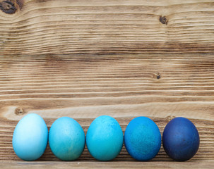 Colorful Easter eggs on wooden background.